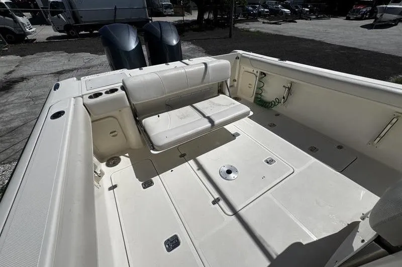 Slide: The Image of 2009 Pursuit 345 Drummond Runner LS boat deck with seating and twin engines. - 29