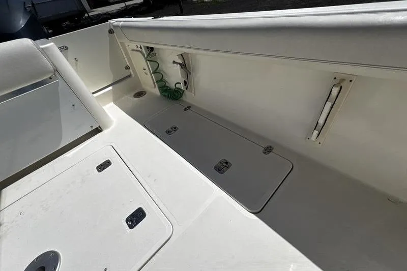 Slide: The Image of 2009 Pursuit 345 Drummond Runner LS boat interior with storage compartments and seating. - 31
