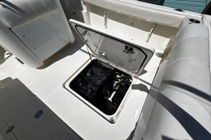 Slide: The Image of Open hatch on 2009 Pursuit 345 Drummond Runner LS boat, revealing internal compartment. - 32