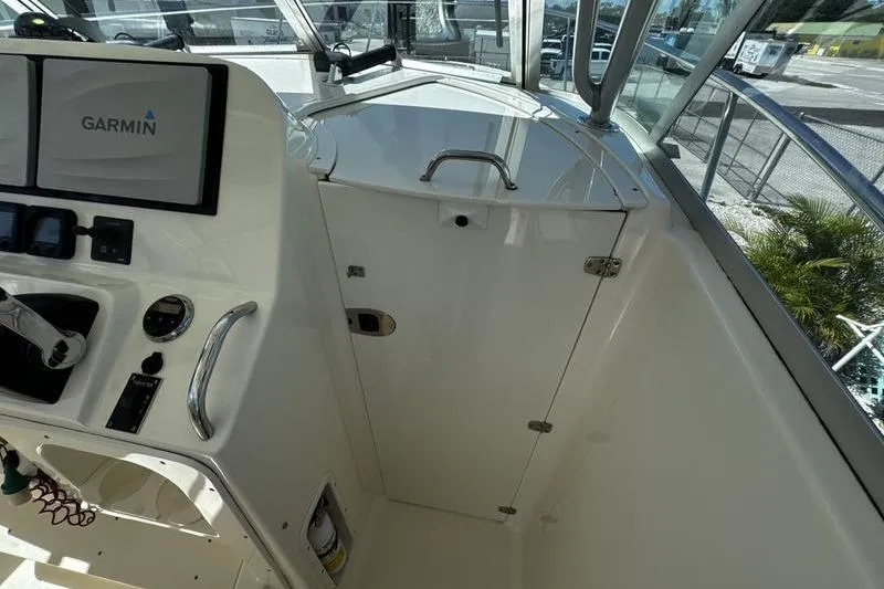 Slide: The Image of 2009 Pursuit 345 Drummond Runner LS boat cockpit with Garmin navigation system. - 33