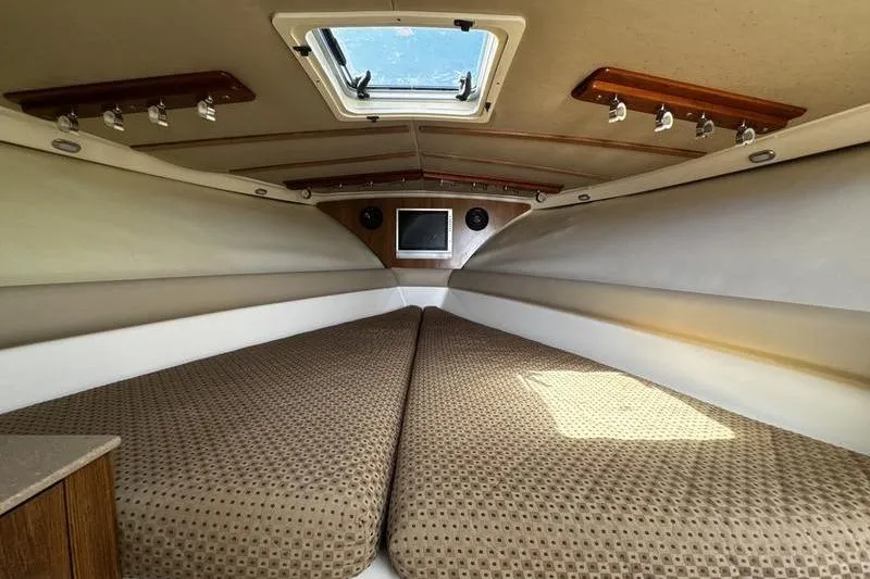 Slide: The Image of Interior cabin of 2009 Pursuit 345 Drummond Runner LS boat with skylight and bedding. - 38