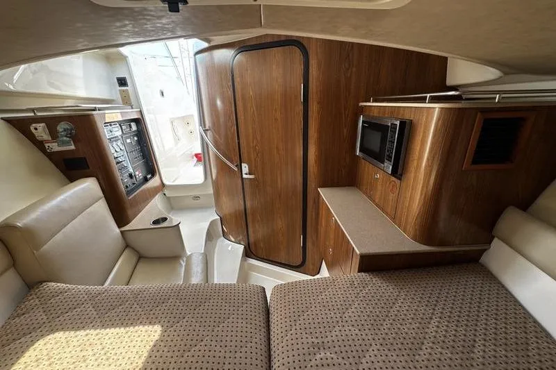 Slide: The Image of Interior of 2009 Pursuit 345 Drummond Runner LS boat with wood paneling and seating. - 41