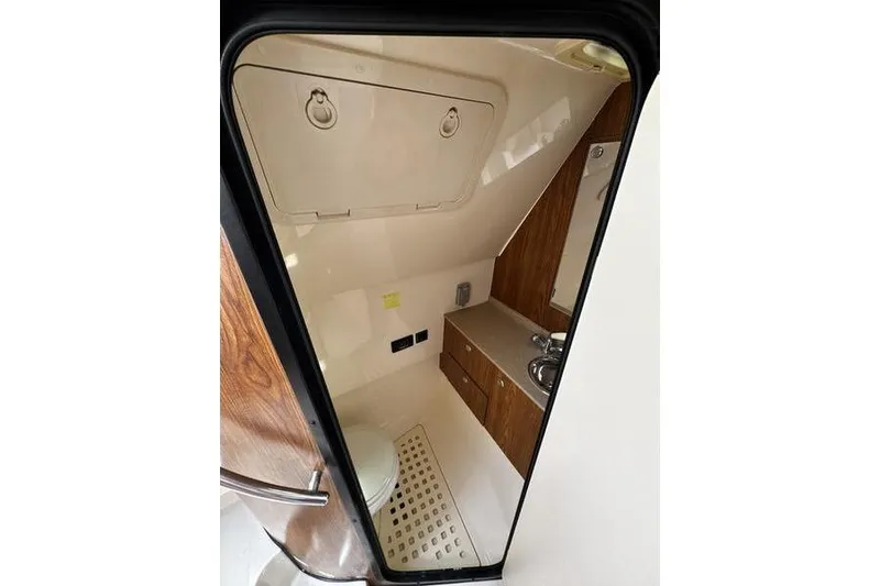 Slide: The Image of Interior of 2009 Pursuit 345 Drummond Runner LS boat bathroom with sink and toilet. - 44