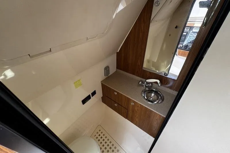 Slide: The Image of Compact bathroom in 2009 Pursuit 345 Drummond Runner LS boat with sink and mirror. - 45