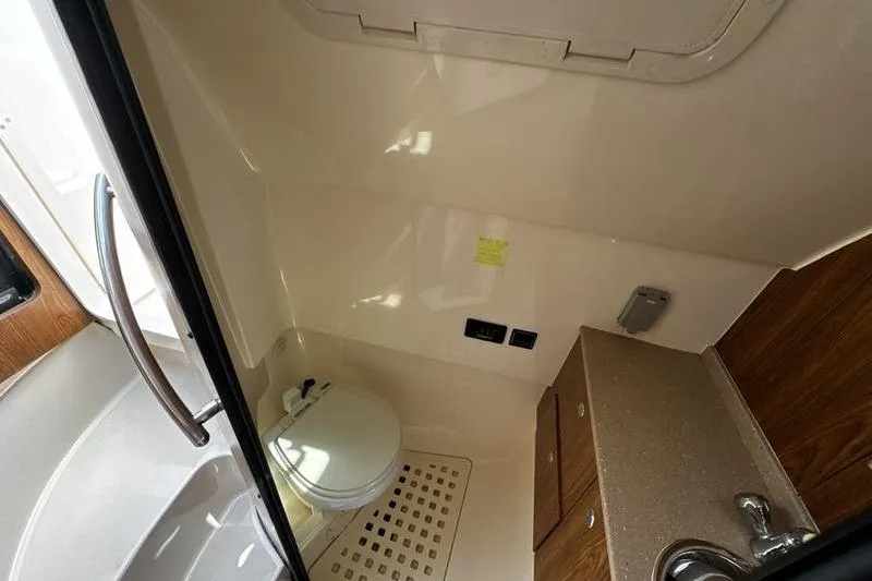 Slide: The Image of Interior of 2009 Pursuit 345 Drummond Runner LS boat bathroom with toilet and sink. - 46