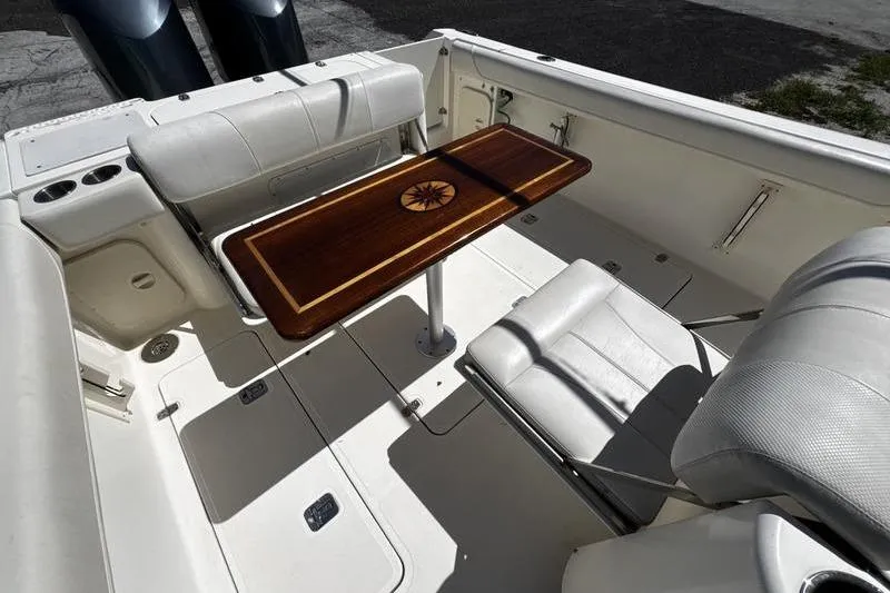 Slide: The Image of 2009 Pursuit 345 Drummond Runner LS boat interior with elegant wooden table and seating. - 50