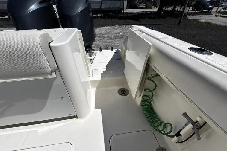 Slide: The Image of 2009 Pursuit 345 Drummond Runner LS boat deck with storage and twin engines. - 51