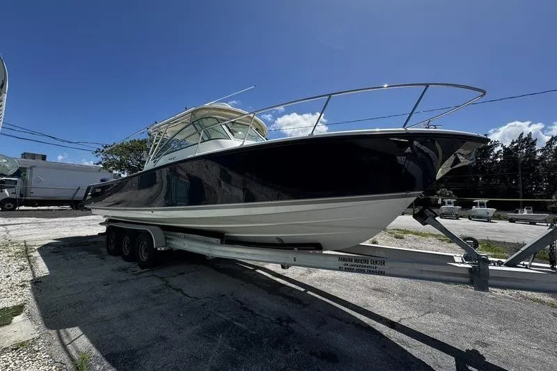 Slide: The Image of 2009 Pursuit 345 Drummond Runner LS boat on trailer under clear blue sky. - 6