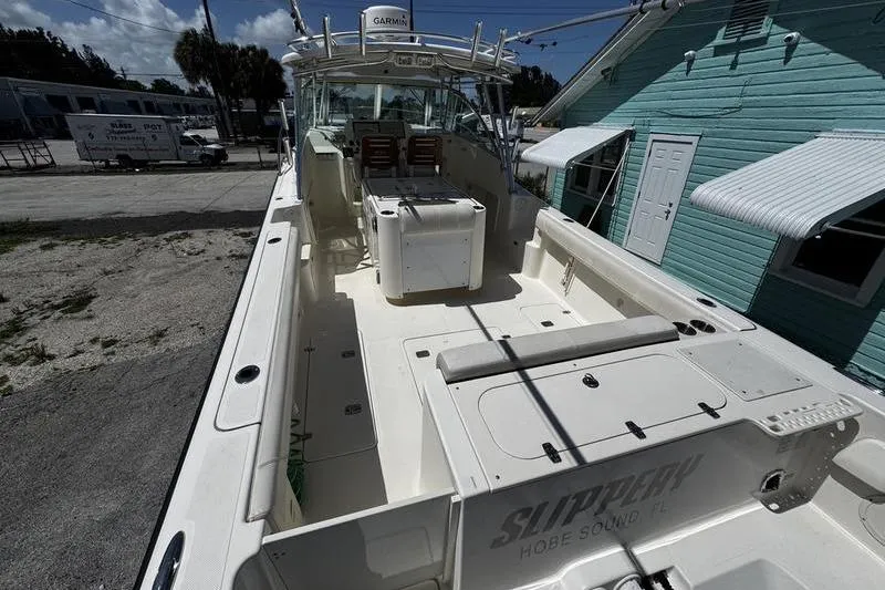 Slide: The Image of 2009 Pursuit 345 Drummond Runner LS boat docked near turquoise building. - 7