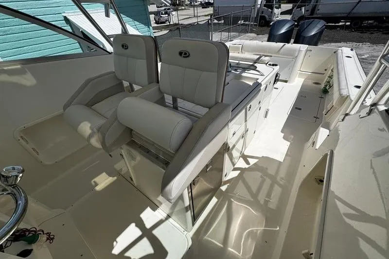 Slide: The Image of 2009 Pursuit 345 Drummond Runner LS boat interior with dual captain's chairs and console. - 9