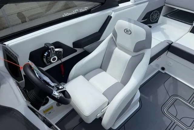 Slide: The Image of 2024 Cobalt CS22 boat interior with white and gray captain's seat and steering wheel. - 13