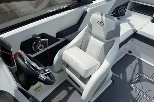 Slide: The Image of 2024 Cobalt CS22 boat interior with white captain's chair and modern steering console. - 14