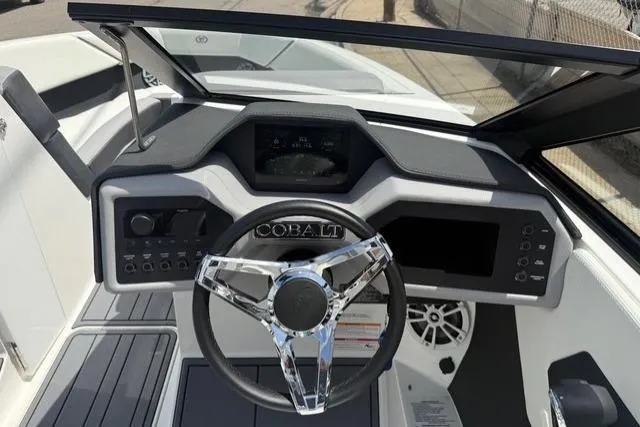 Slide: The Image of 2024 Cobalt CS22 boat dashboard with modern steering wheel and control panel. - 15