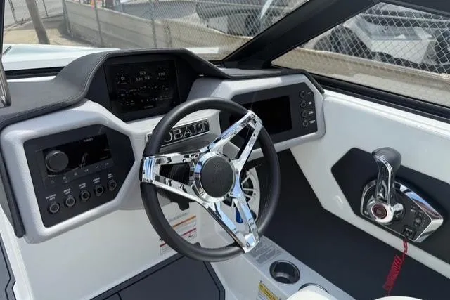 Slide: The Image of 2024 Cobalt CS22 boat dashboard with modern steering wheel and control panel. - 16