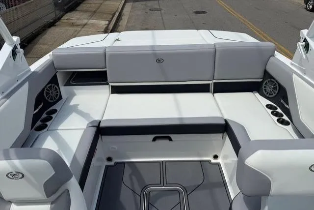 Slide: The Image of 2024 Cobalt CS22 boat interior with gray seating and cup holders. - 19