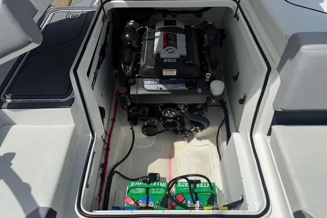 Slide: The Image of 2024 Cobalt CS22 boat engine compartment with visible battery and components. - 20