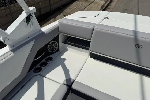 Slide: The Image of 2024 Cobalt CS22 boat interior with white and gray seating, cup holders, and speaker. - 21