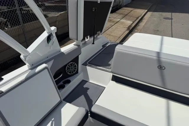 Slide: The Image of 2024 Cobalt CS22 boat interior with white and gray seating, cup holders, and speaker. - 22