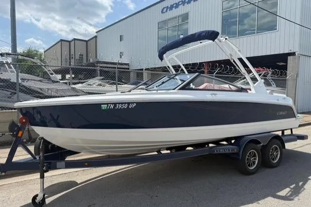 Slide: The Image of 2024 Cobalt CS22 boat on trailer outside dealership, sunny day. - 7