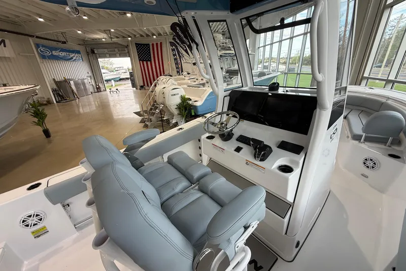 Slide: The Image of 2026 Sportsman Open 232 Center Console boat interior with modern helm and seating. - 11