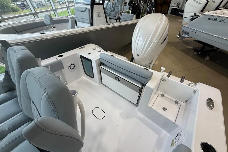 Slide: The Image of 2026 Sportsman Open 232 Center Console boat interior with seating and Yamaha engine. - 13