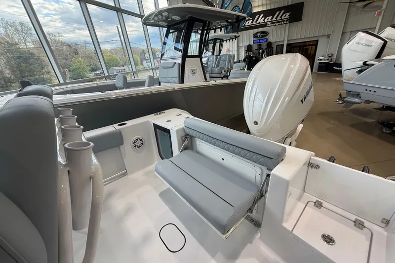 Slide: The Image of 2026 Sportsman Open 232 Center Console boat interior with seating and Yamaha outboard motor. - 15