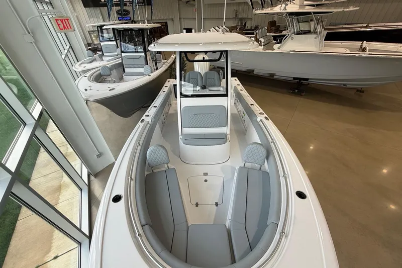 Slide: The Image of 2026 Sportsman Open 232 Center Console boat displayed in a showroom. - 3