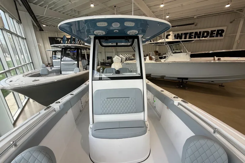Slide: The Image of 2026 Sportsman Open 232 Center Console boat displayed in a showroom. - 6