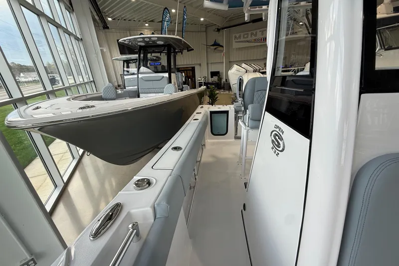 Slide: The Image of 2026 Sportsman Open 232 Center Console boat displayed in a showroom. - 7