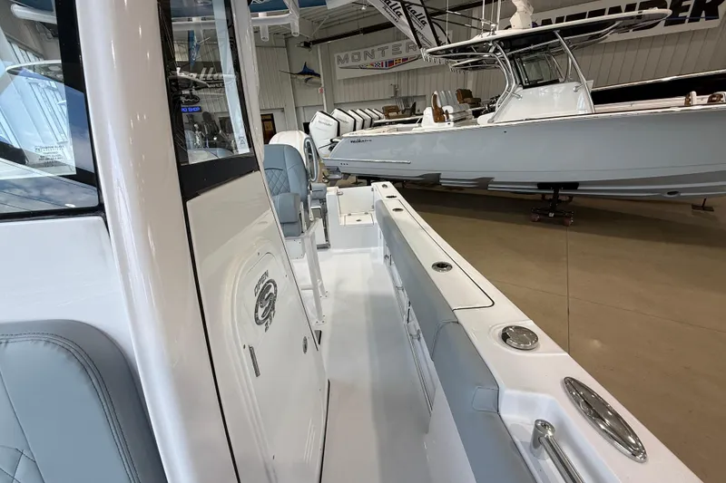Slide: The Image of 2026 Sportsman Open 232 Center Console boat displayed in a showroom. - 8