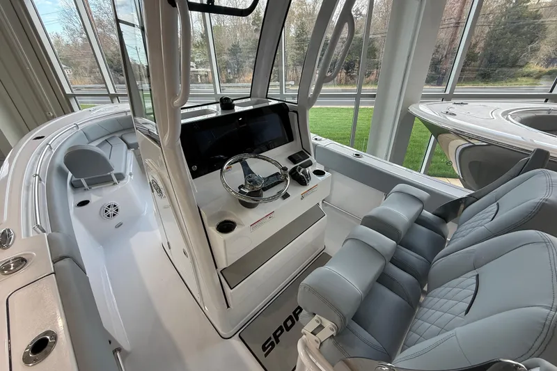 Slide: The Image of 2026 Sportsman Open 232 Center Console boat interior with modern helm and seating. - 9