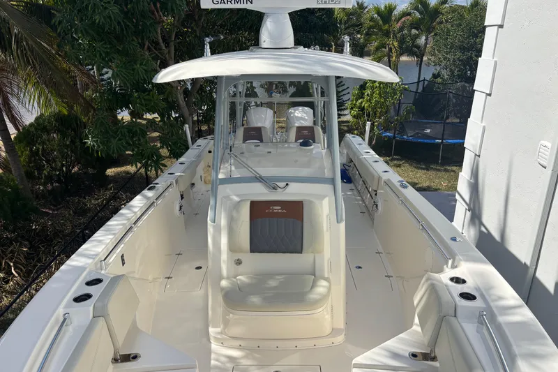 Slide: The Image of 2021 Cobia 320 Center Console boat with Garmin equipment, docked outdoors. - 5