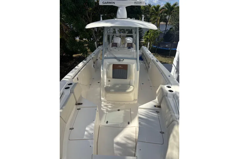 Slide: The Image of 2021 Cobia 320 Center Console boat with spacious deck and Garmin equipment. - 6