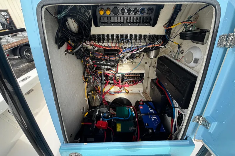 Slide: The Image of Electrical compartment of 2023 Pathfinder 2300 HPS boat, showcasing wiring and battery setup. - 10