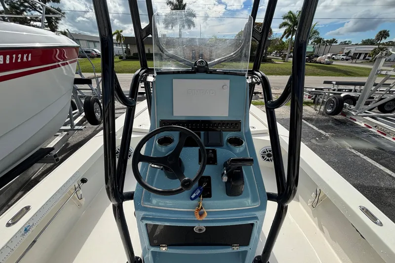 Slide: The Image of 2023 Pathfinder 2300 HPS boat console with steering wheel and controls. - 11