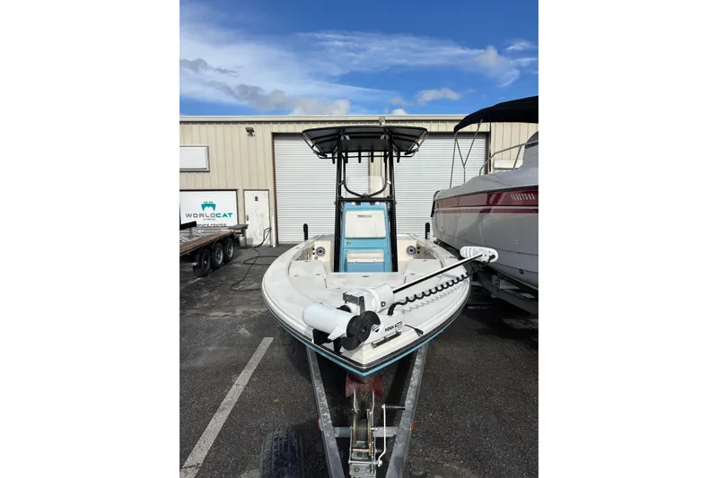 Slide: The Image of 2023 Pathfinder 2300 HPS boat on trailer, parked outside a warehouse. - 12