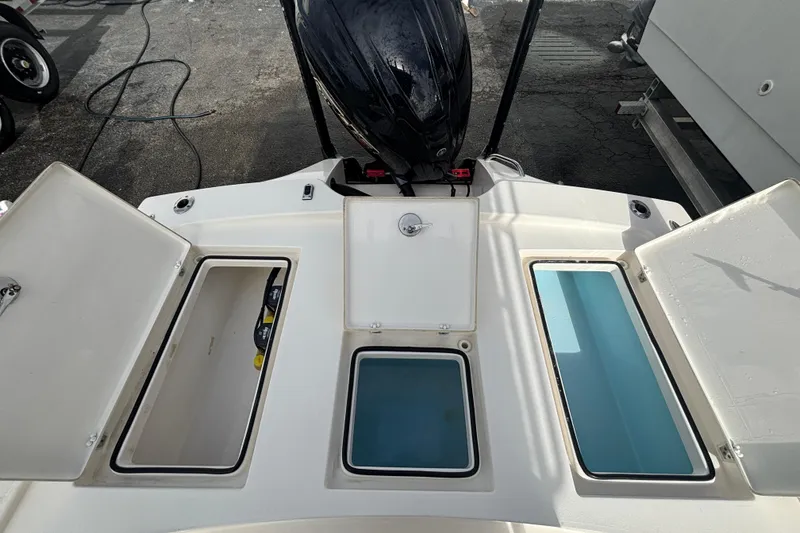 Slide: The Image of 2023 Pathfinder 2300 HPS boat storage compartments and engine view. - 14