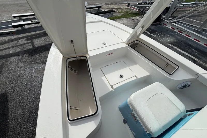 Slide: The Image of 2023 Pathfinder 2300 HPS boat interior with open storage compartments and seating. - 5