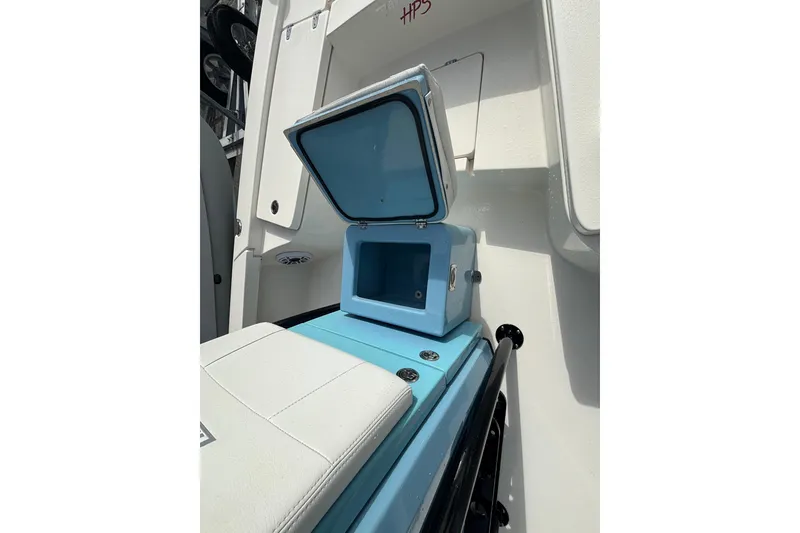 Slide: The Image of Open storage compartment on 2023 Pathfinder 2300 HPS boat, featuring light blue interior. - 8