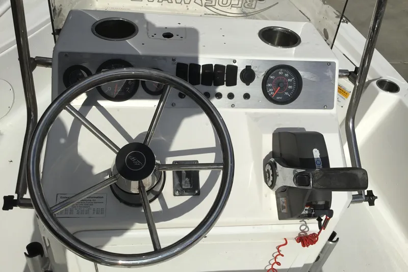 Slide: The Image of 2013 Blue Wave 1900 STL boat dashboard with steering wheel and controls. - 10