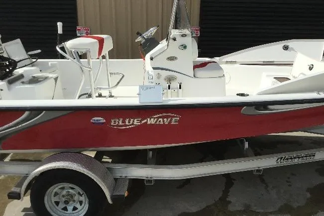 Slide: The Image of 2013 Blue Wave 1900 STL boat on trailer, red and white design. - 11