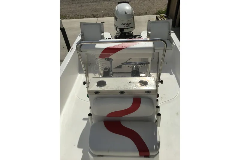 Slide: The Image of 2013 Blue Wave 1900 STL boat interior with steering console and Evinrude 130 engine. - 12