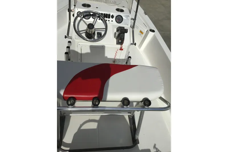 Slide: The Image of 2013 Blue Wave 1900 STL boat interior with steering wheel and red-accented seat. - 13