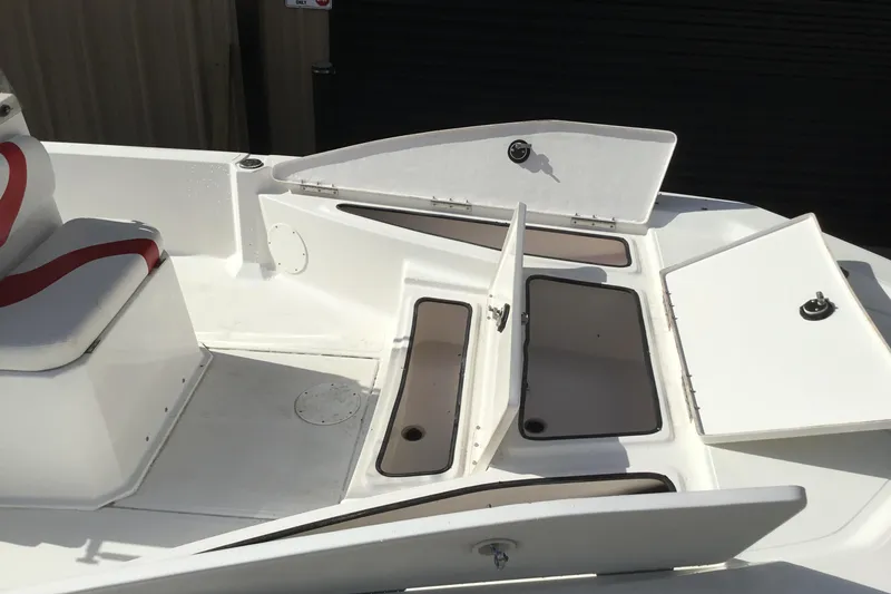 Slide: The Image of 2013 Blue Wave 1900 STL boat with open storage compartments and seating. - 18