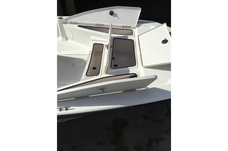 Slide: The Image of 2013 Blue Wave 1900 STL boat with open storage compartments on deck. - 21