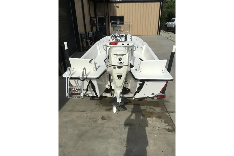 Slide: The Image of 2013 Blue Wave 1900 STL boat with 130 HP engine, parked on concrete. - 24