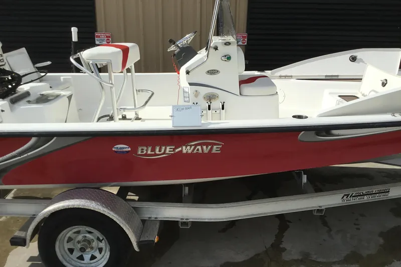 Slide: The Image of 2013 Blue Wave 1900 STL boat on trailer, red and white design. - 3