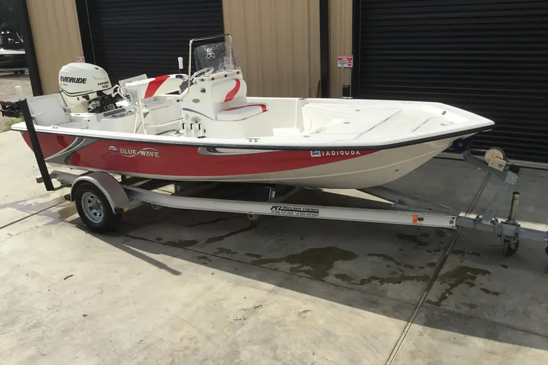 Slide: The Image of 2013 Blue Wave 1900 STL boat on trailer, red and white design, parked outside. - 5