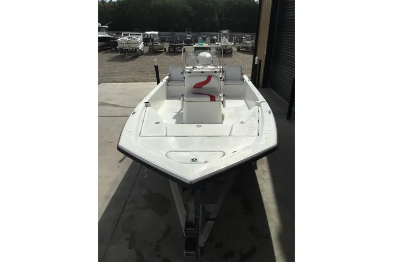 Slide: The Image of 2013 Blue Wave 1900 STL boat in storage, showcasing sleek design and spacious deck. - 7