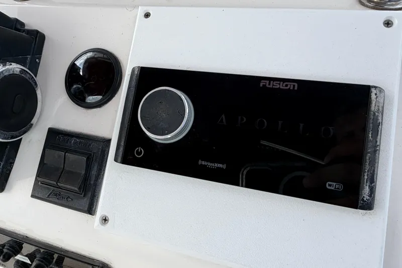 Slide: The Image of Control panel of a 1997 Wellcraft 302 Scarab Sport boat featuring a Fusion Apollo stereo system. - 10